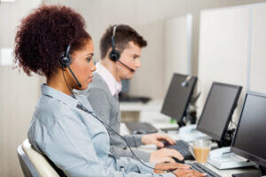 Two-call-center-professionals-on-computers-300x200